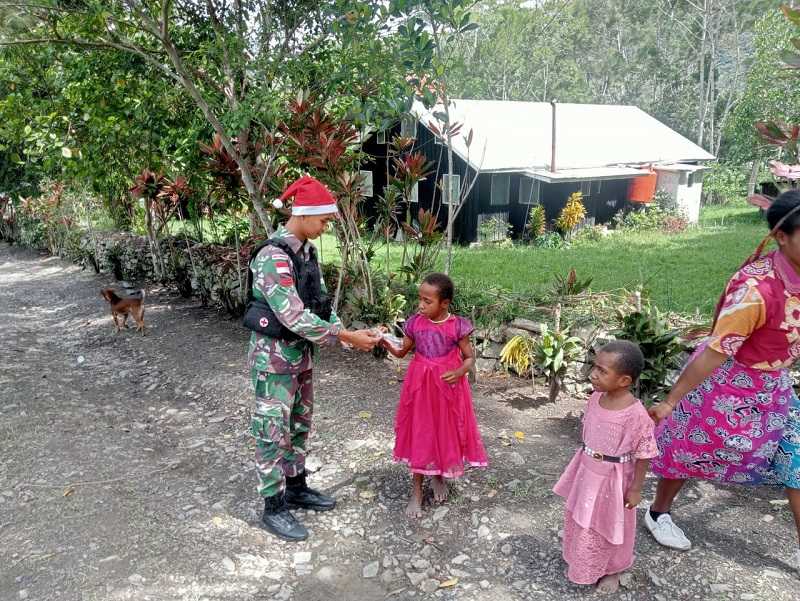 Ada Apa Tiba-tiba Anggota Satgas Yonif Raider 142/KJ Keliling Kampung di Tengah Momen Parayaan Natal